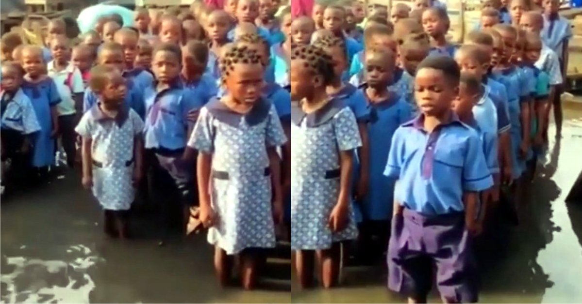 "This is wickedness o" - Nigerians React to the viral video of school pupils singing the National anthem in their flooded school premises
