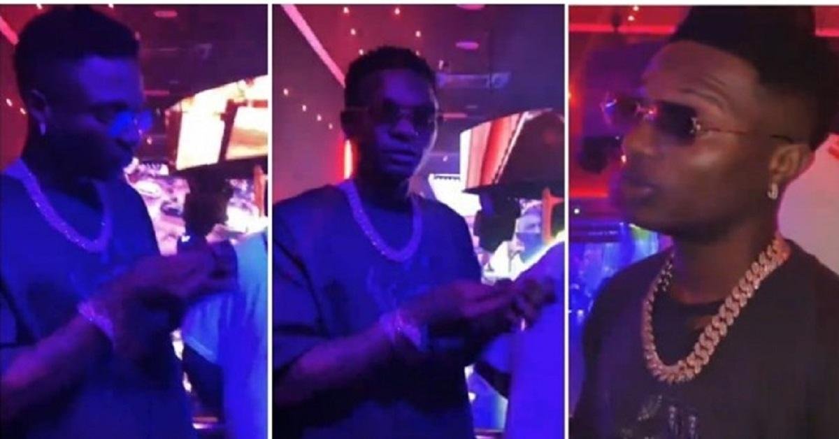 Moment Wizkid stopped a woman from filming him rolling weed inside a club (Video)